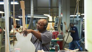 Portrait of an employee working with an unfinished instrument inside the Gibson guitar factory in Memphis, Tennessee, taken on September 9, 2013