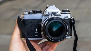 Nikon FE held in a single hand outside