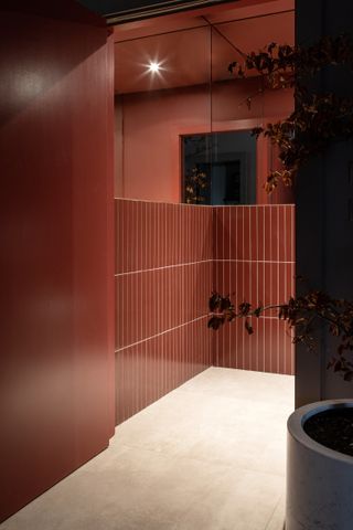 A red bathroom with beige floor tiles