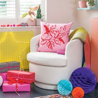 Christmas living room with swivel chair and pink cushion