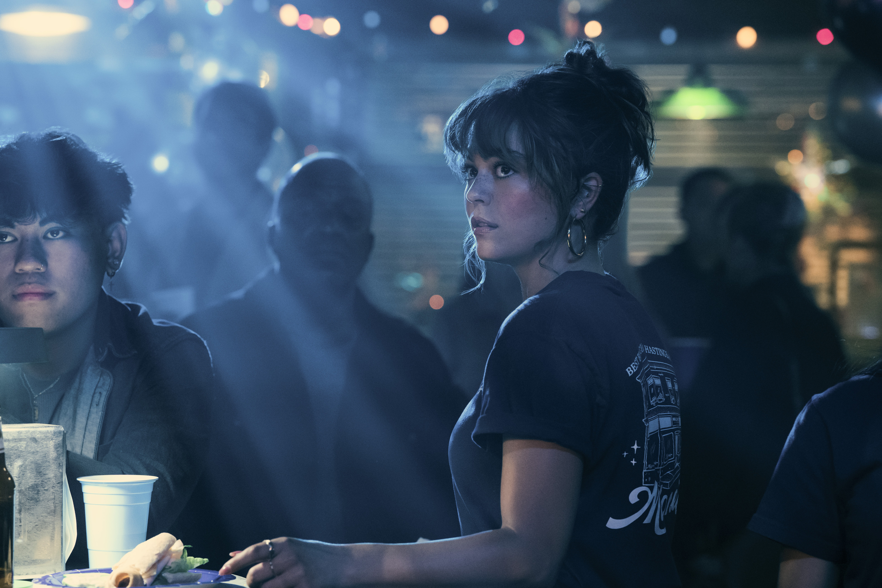 Allie Hayes (Mika Abdalla) works as a server during a live-music night in a crowded campus bar in 'OFF CAMPUS.'