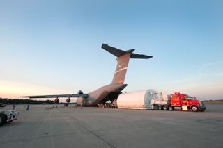 A "pathfinder" simulated telescope to help with James Webb Space Telescope assembly is unloaded from a from a C-5 aircraft at the U.S. Air Force's Joint Base Andrews in Maryland. This is the same procedure used to ship JWST components.