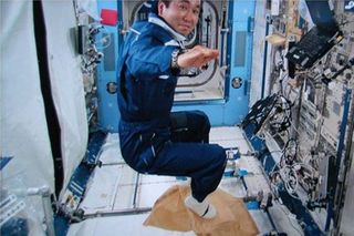 Astronaut Koichi Wakata conducts the "Magic Carpet" activity as part of a session of Try Zero-G experiment on the International Space Station.