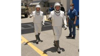 NASA astronauts Bob Behnken and Doug Hurley walk out of NASA's Astronaut Crew Quarters and take a Tesla Model X to Launch Pad 39A during a dry-run test of their SpaceX Crew Dragon Demo-2 flight on May 23, 2020 at the Kennedy Space Center in Florida.