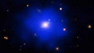 SPT2215 as seen by NASA’s Chandra X-ray Observatory (blue) and NASA’s Hubble Space Telescope (cyan and orange).