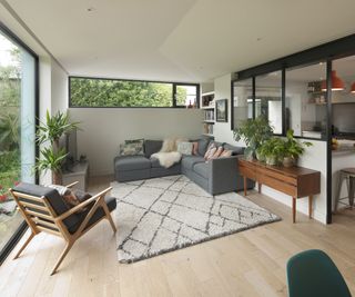 A shallow pitched roof extension with cosy living room and l shaped sofa