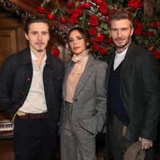 David, Victoria and Brooklyn Beckham attend the Kent & Curwen presentation at London Fashion Week in 2019