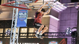 Vance Walker hanging off a pulley on American Ninja Warrior season 16