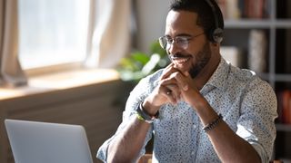 Man using a headset for video and voice calling on a laptop