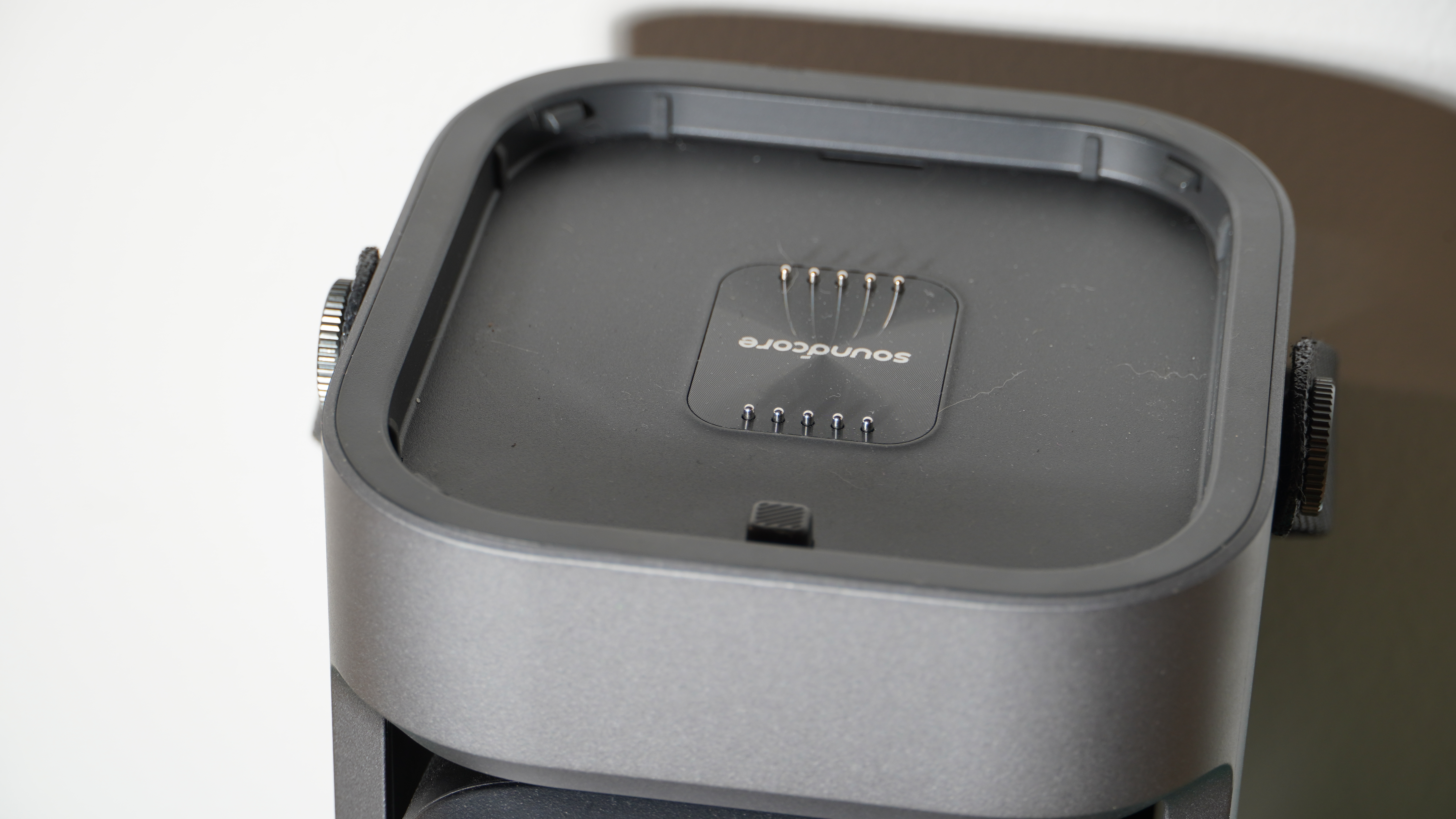 The little charging pins on top of the Soundcore Nebula P1 projector
