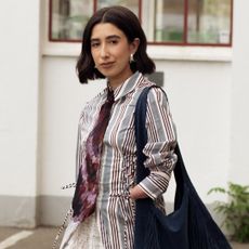 April Lockhart wearing a striped shirt with a burgundy tie at copenhagen fashion week