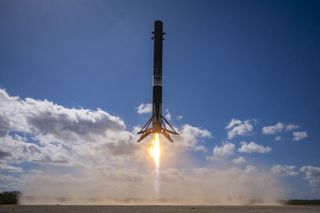The first stage of a SpaceX Falcon 9 rocket comes down for a landing at Cape Canaveral Space Force Station shortly after launching 40 OneWeb internet satellites on March 9, 2023.