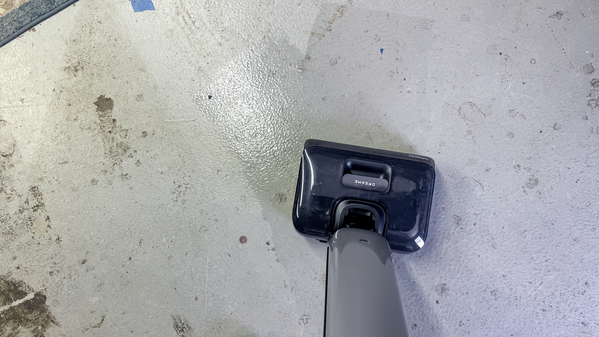 Dreame Aero Pro Wet Dry Vacuum mopping up wine on a concrete floor