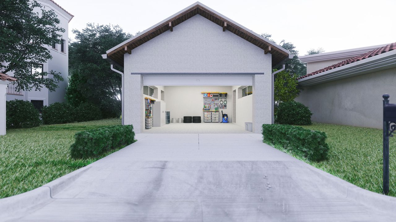 Concrete driveway leading up to open garage