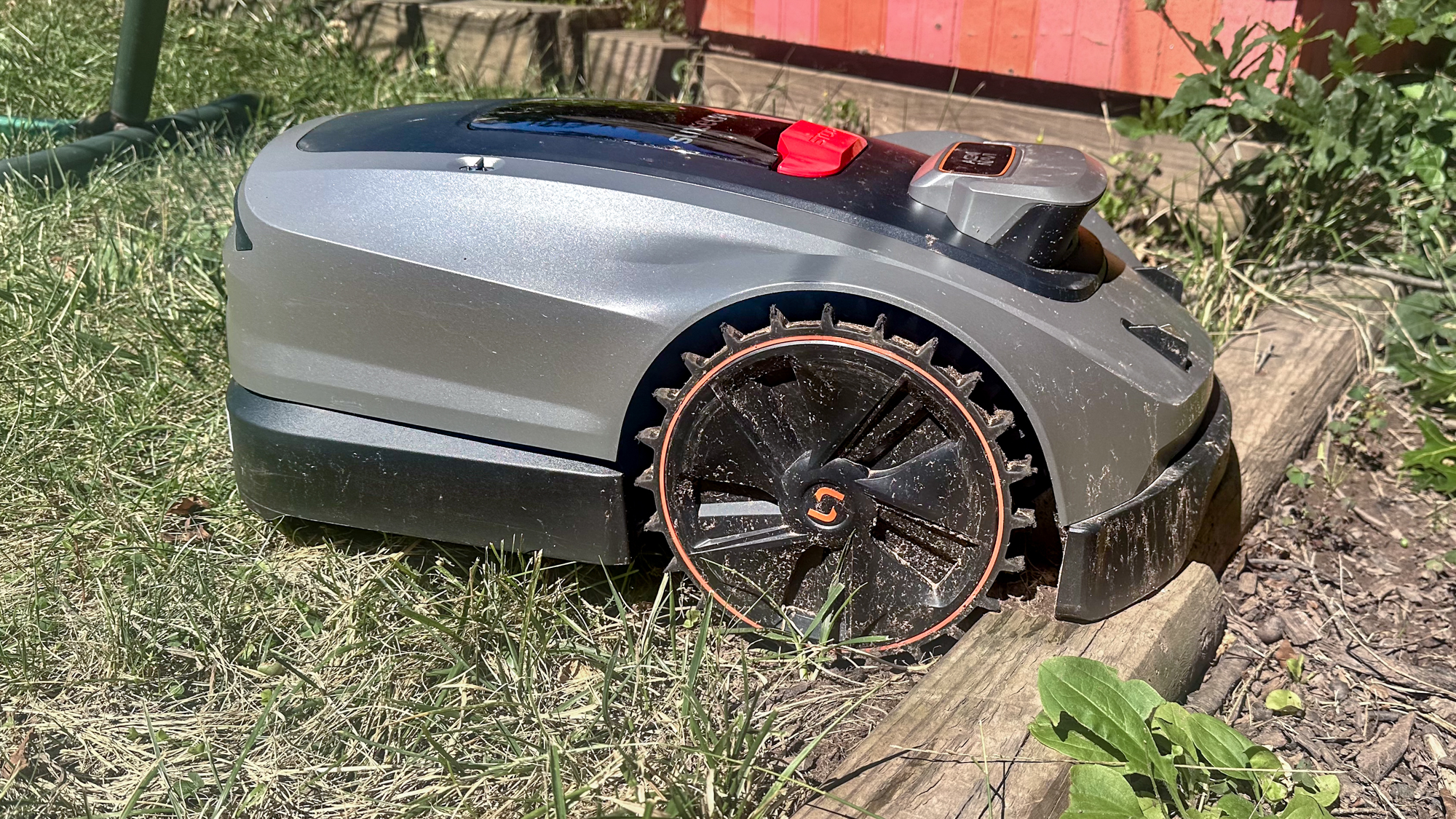 Sunseeker X3 Plus robot lawnmower stuck on a garden bed divider