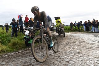 Tom Van Asbroeck of Belgium and Team Israel Start-Up Nation covered in mud covered in mud competes through cobblestones sector during the 118th Paris-Roubaix 2021