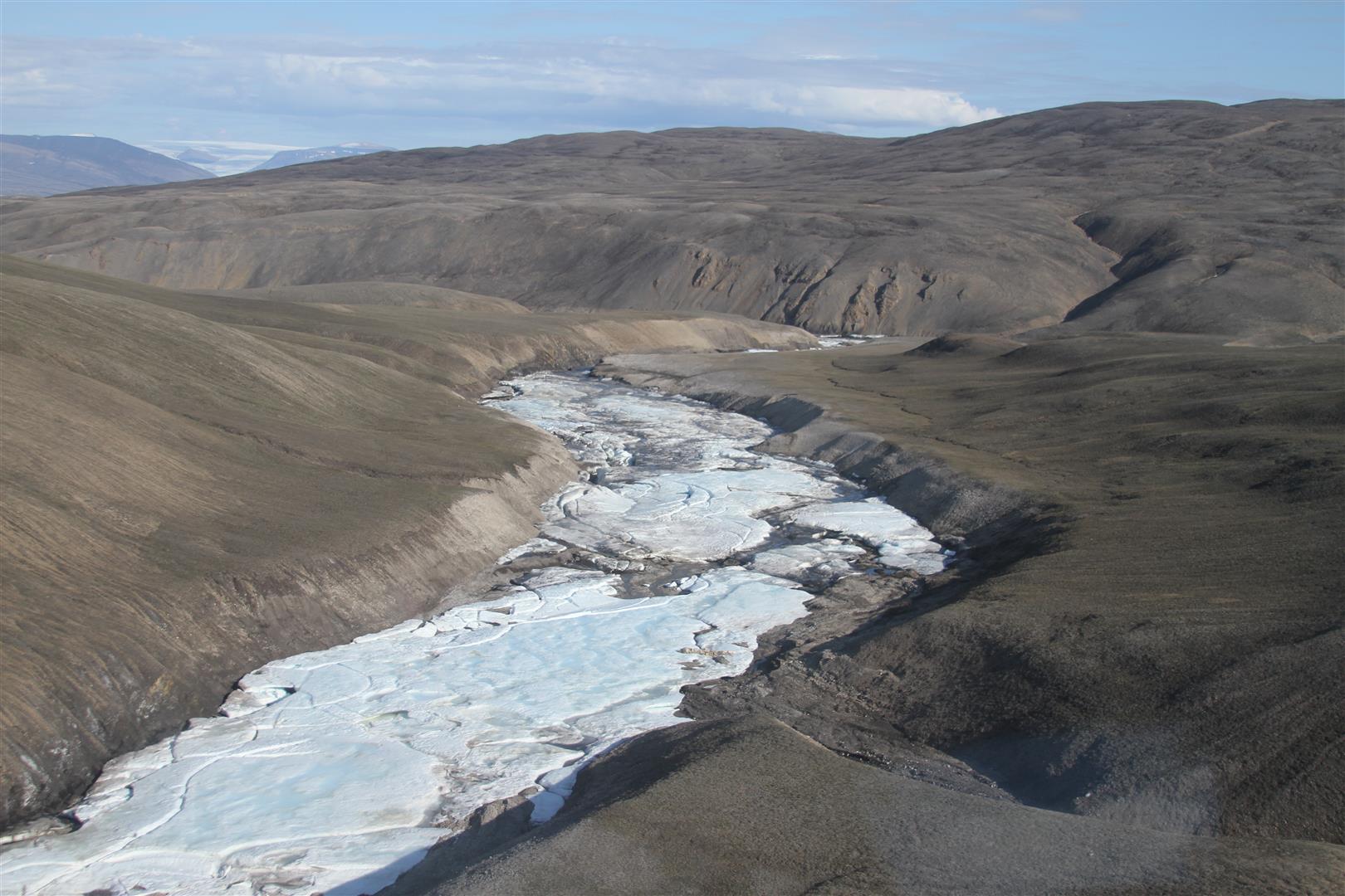 An ice-filled river channel below the spring.