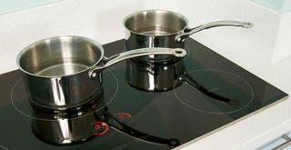 stainless steel saucepans on an induction hob