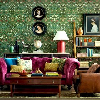 living room with pink sofa and green wallpaper