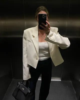 Woman wearing cropped white blazer