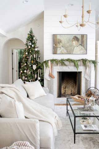 white living room with christmas tree in corner