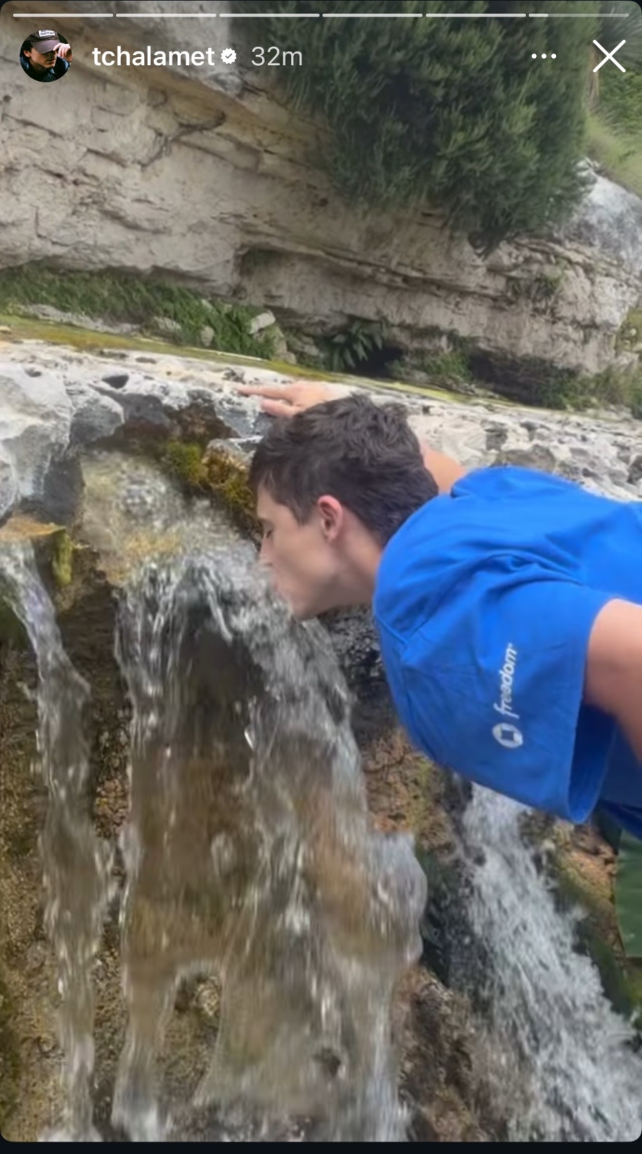 Timoth&eacute;e Chalamet drinking water from a fountain. 