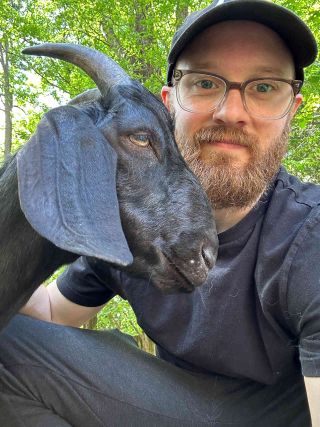Jay Postones of Tesseract with his pet goat Newt