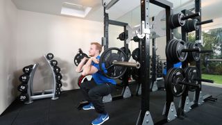 man lifting weight at a power rack