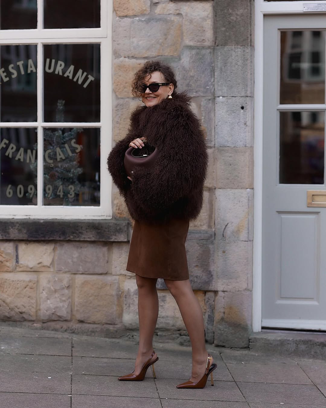 renia jaz wears a brown mongolian shearling coat