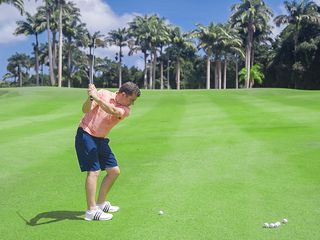 Dan Grieve hitting a pitch shot as part of a pitching drill on the fairway