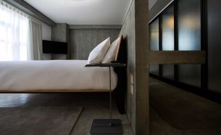 Bed in concrete finish room