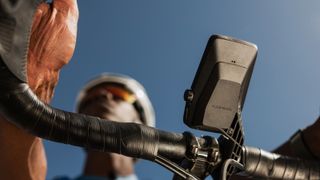 The underside of the Coros Dura computer on the front of a bike