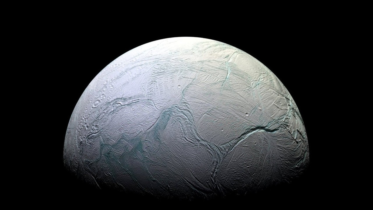 a pale blue and white orb with streaks throughout its surface