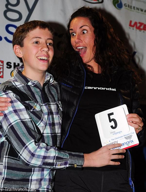 Nicole Duke (Cannondale) being presented her race number by a boy from Bend