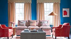 blue living room with patterned sofa and curtains
