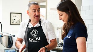 Nigel Mitchell and cyclist Manon Lloyd in a kitchen