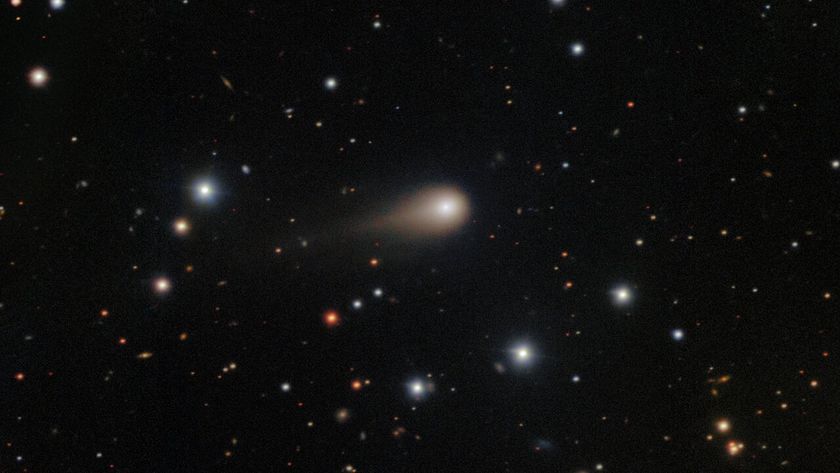 a photo of the comet 3I/ATLAS with its long tail shooting through space