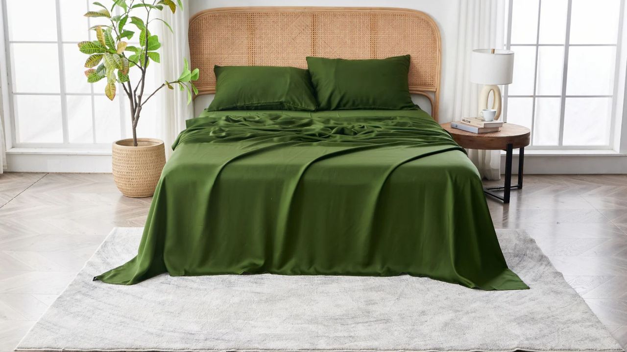 Sijo Eucalyptus Sheet Set on a bed against white walls. 