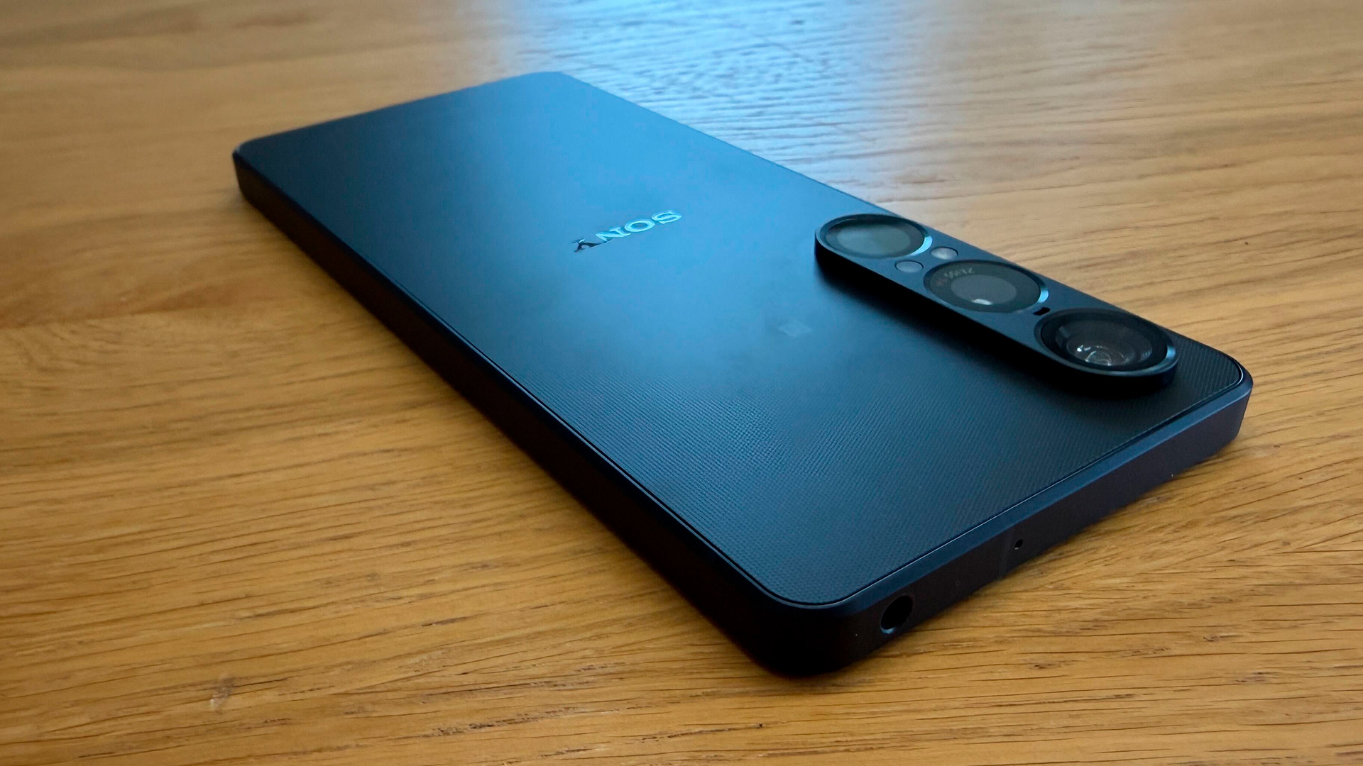 Sony Xperia 1 VII smartphone laid face down on wooden surface