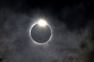 The diamond ring effect is seen a the moon eclipses the sun above Fort Worth, Texas.
