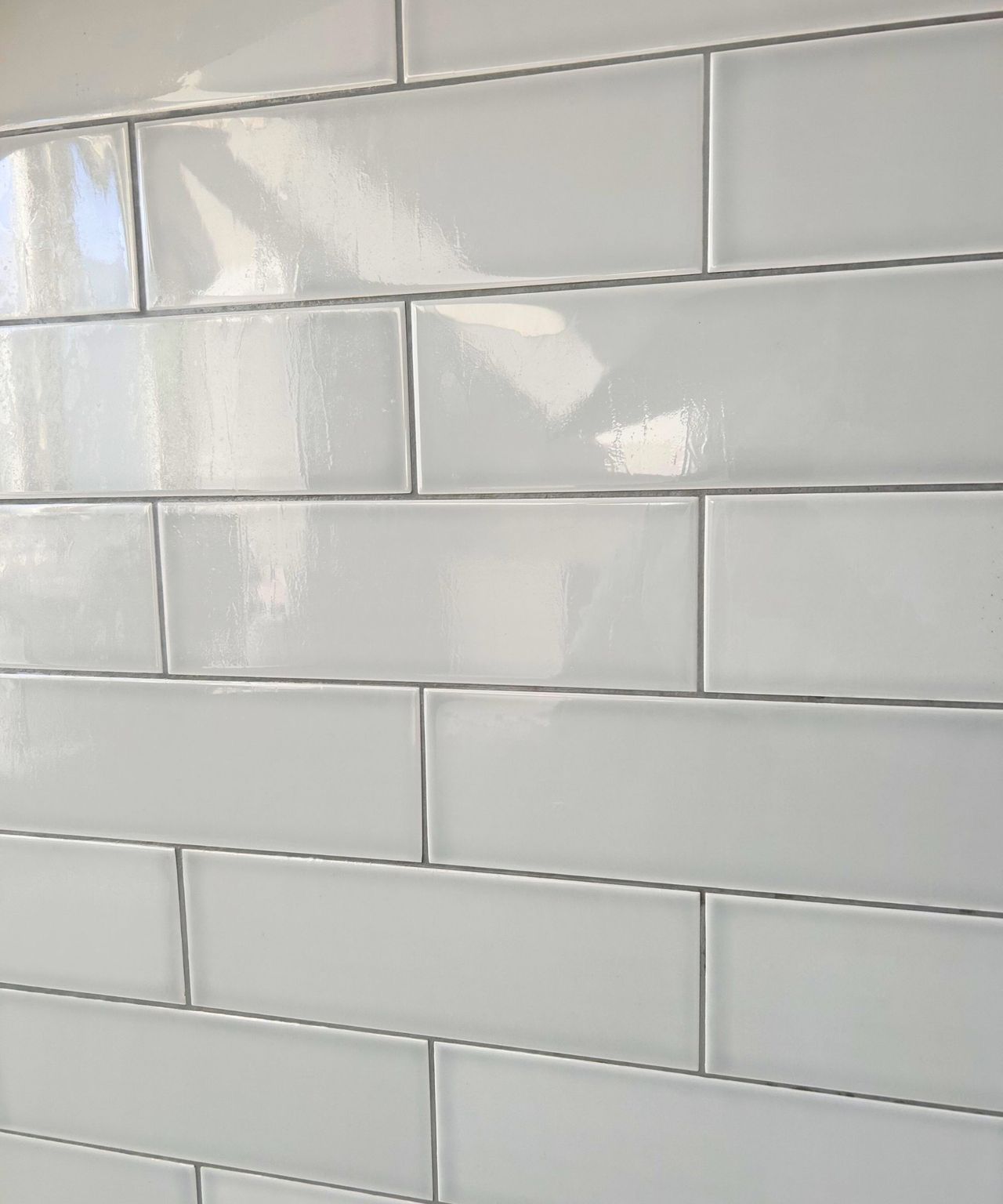 After using the SonicScrubber, soap scum, mold and grime gone from the gray tiles