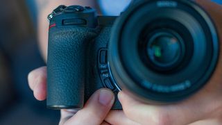 Man holding Nikon Z6 II and pointing at Fn2 button