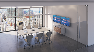 An empty conference room adorned with MAXHUB displays and Extron control. 