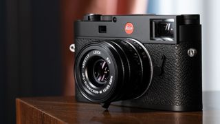 The Leica M11 camera on a wooden table