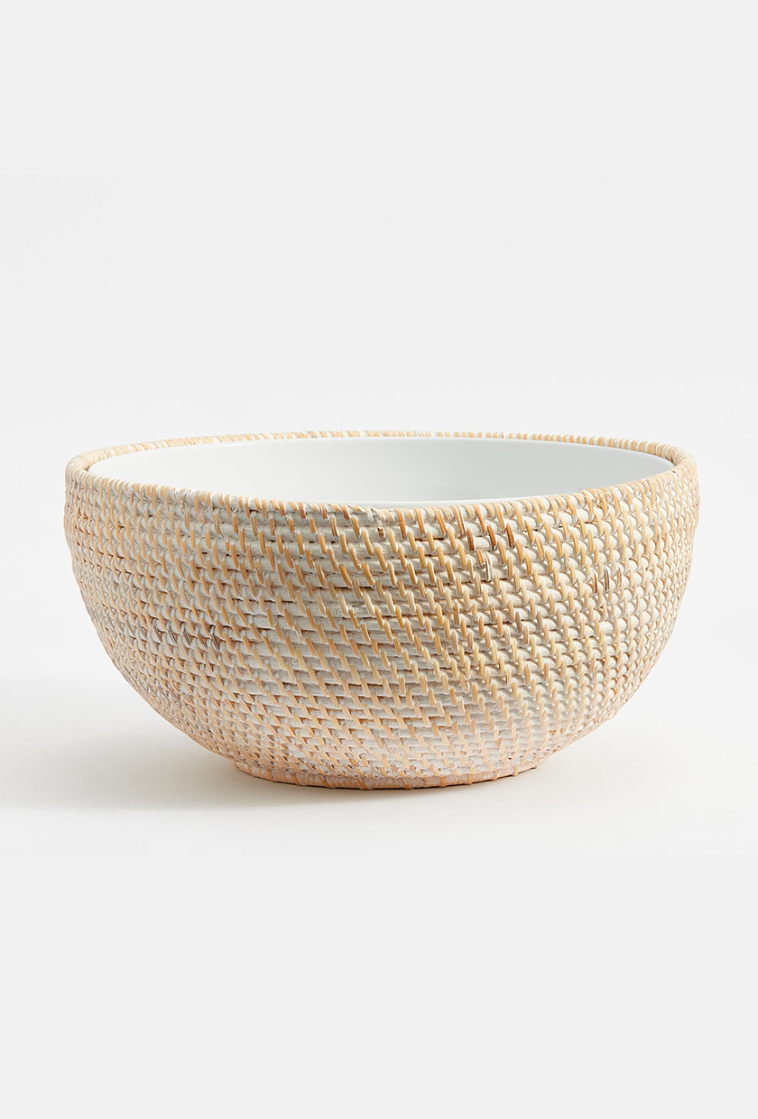 Large white serving bowl with rattan weaving on the outside from Pottery Barn