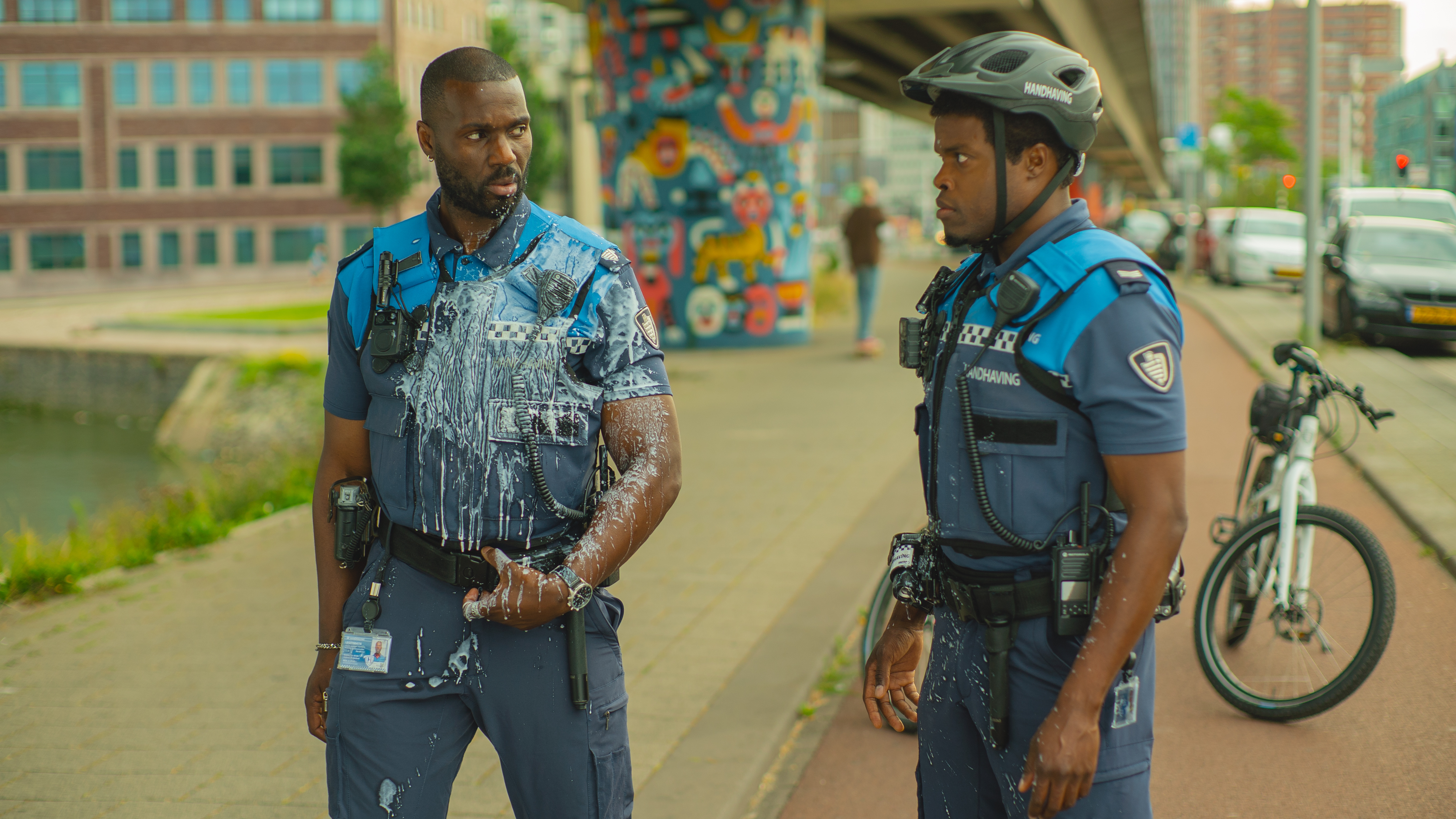 L-R: Jack (Werner Kolf) covered in a milkshake standing next to Ramon (Jandino Asporaat) in a scene from Netflix's "Almost Cops"