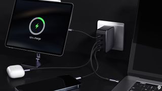 The Ugreen Nexode 100W GaN charger plugged with multiple devices