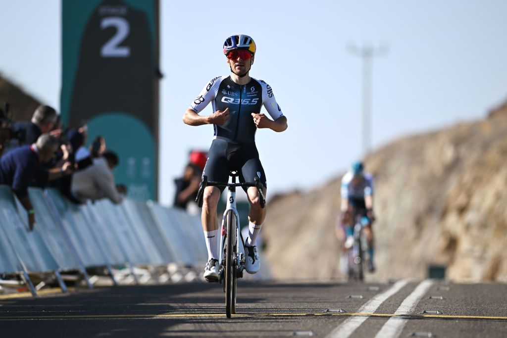 Tom Pidcock points to his Q36.5 jersey as he wins stage 2 of the AlUla Tour