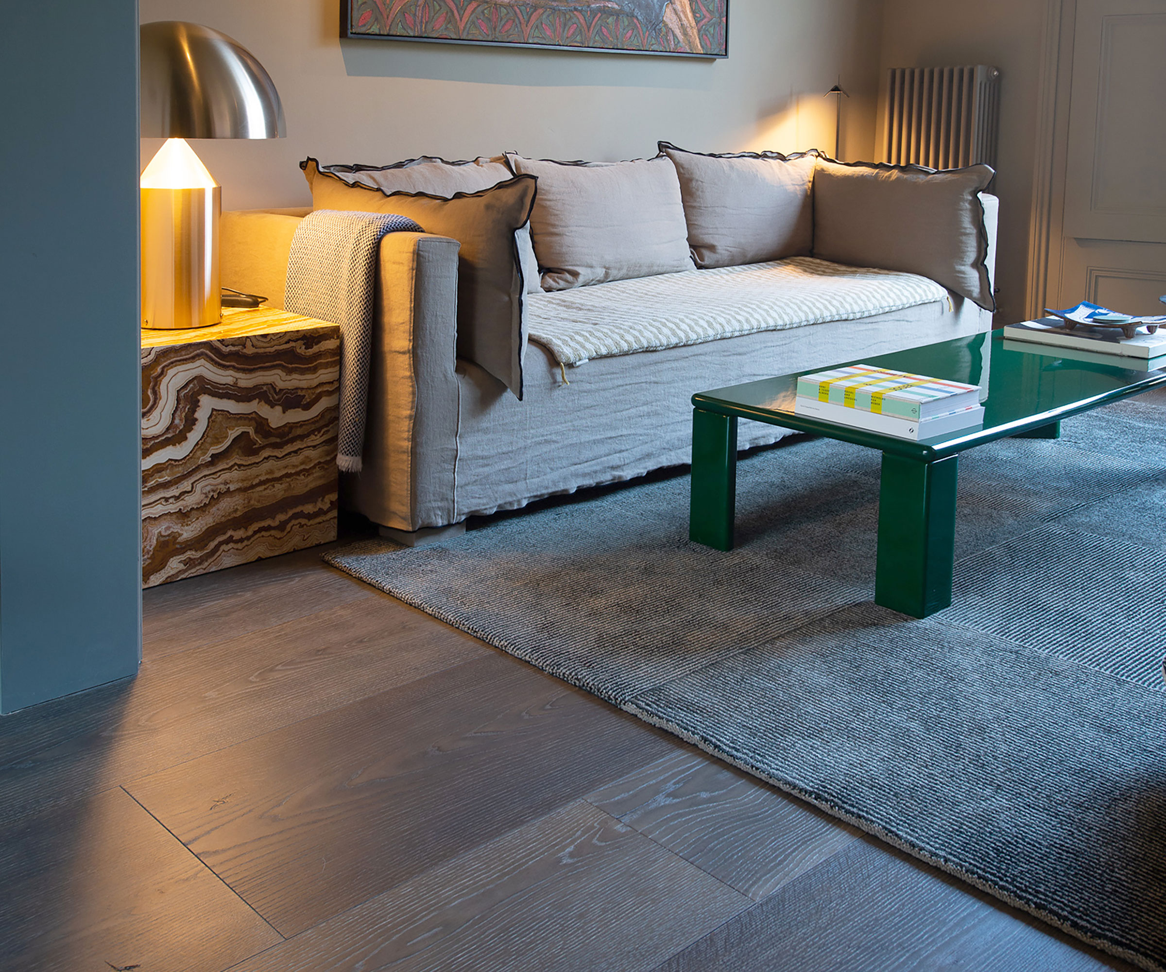 cosy living room with wide plank wooden flooring and cream linen sofa