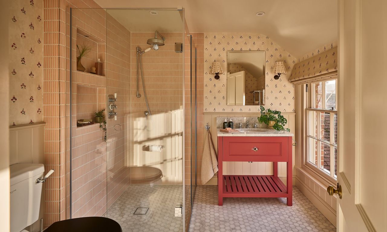 a beige bathroom with a bright red vanity